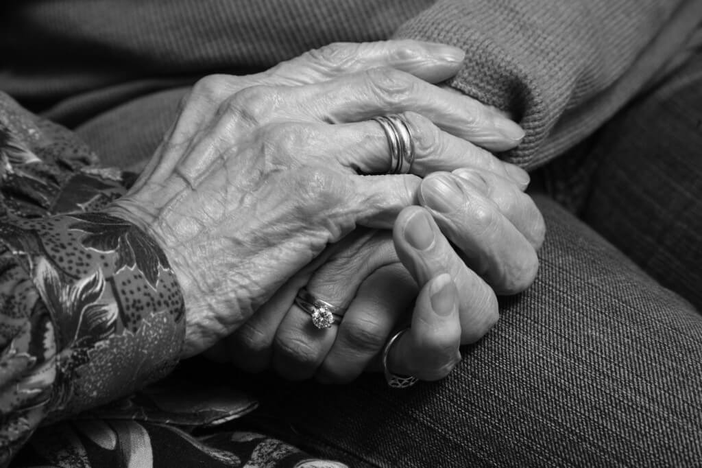 Seniors holding hands closeup